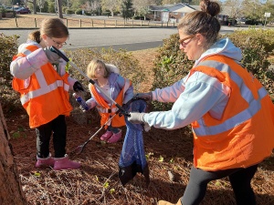 Family-friendly service day involved Rotarians' spouses and children in park cleanup.