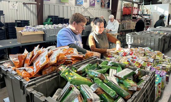 Rotarians sort and pack food for low-income children at NourishNC